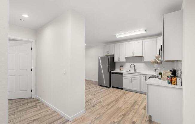 a kitchen with a sink and a refrigerator