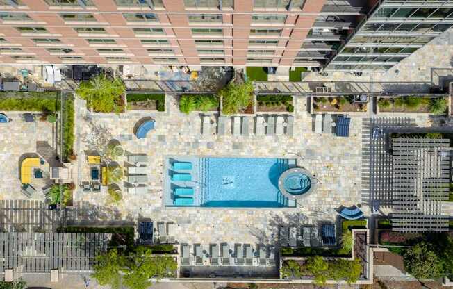 A large outdoor swimming pool surrounded by a stone wall.