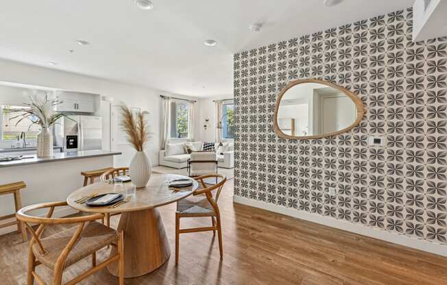 a dining room with a table and chairs and a mirror