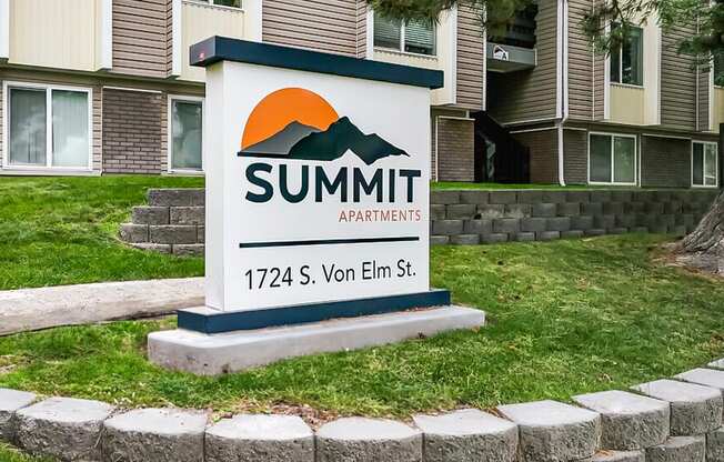 a sign for summit apartments in front of a building at Summit, Idaho, 83201