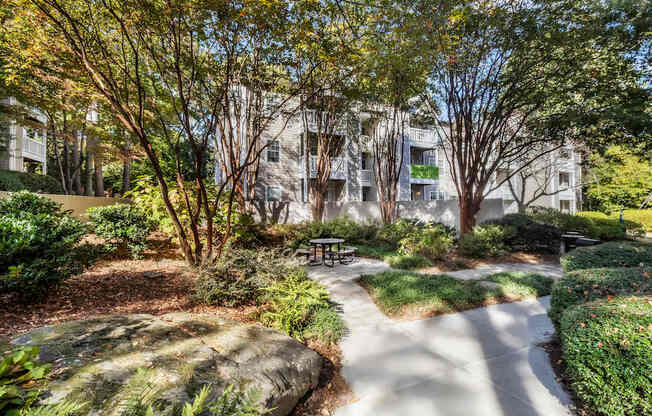 A park with a walking path and a bench.