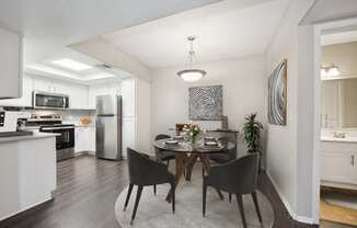 a dining room with a table and black chairs