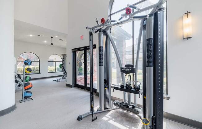 A gym with a row of squat racks.