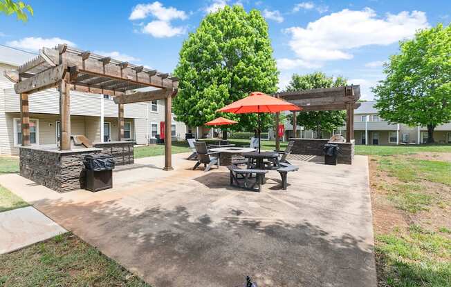 our apartments have a patio with picnic tables and umbrellas