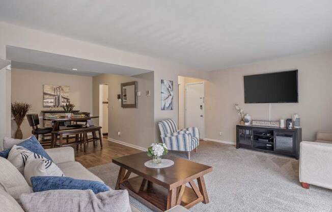 a living room with a couch and a coffee table in front of a tv