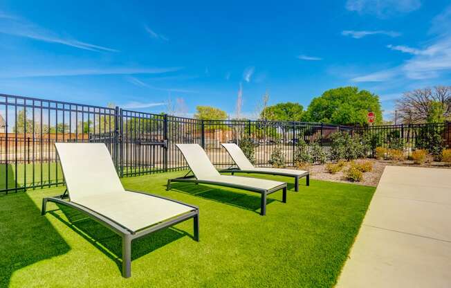 Poolside lounge chairs with outdoor yard