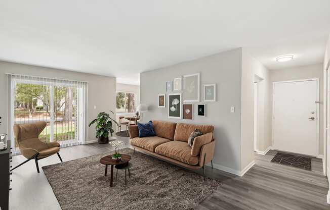 a living room with a couch and a chair and a rug