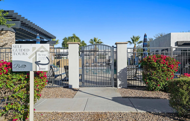 The gate of a self-guided tours sign is open.