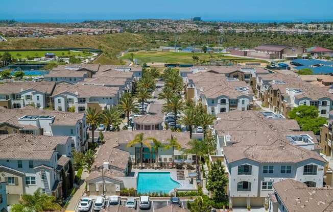 A view of a residential area with houses and a pool.