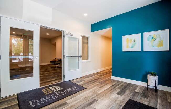 Lobby with First Point Management Matt over Wood Inspired Floor, Turquoise Walls and Empty Room with Open Windows