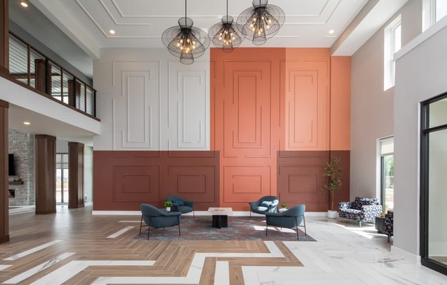 A large room with a wooden floor and a patterned rug.