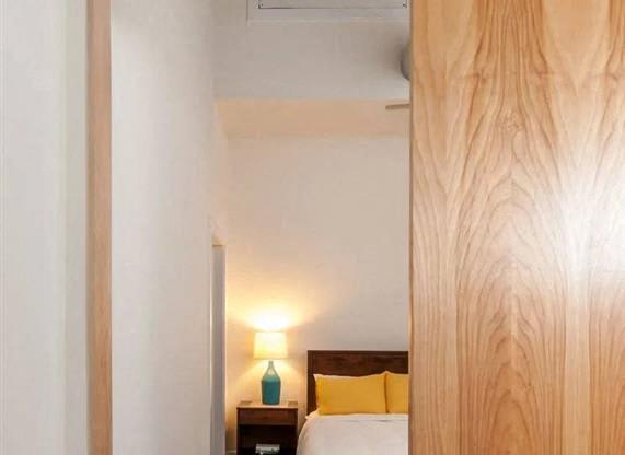 a bedroom with a bed and a sliding wooden door