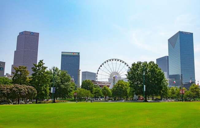 A large Ferris wheel is in the background of a city park.