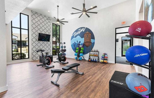 a home gym with a large mural on the wall