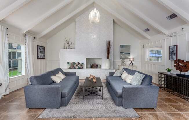 a living room with two couches in front of a fireplace