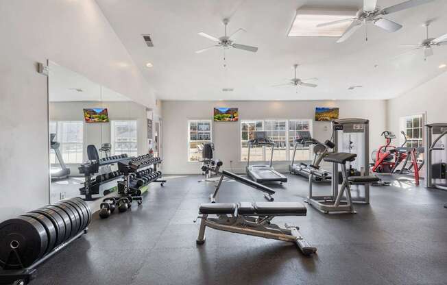 A spacious gym with a variety of equipment including weights and cardio machines.