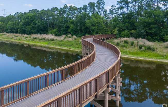 A wooden walkway curves around a body of water.