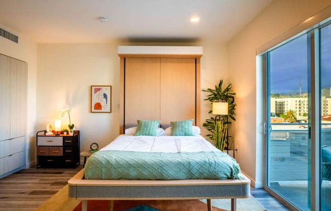 a bedroom with a bed and a large window