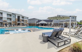 our apartments offer a swimming pool with lounge chairs and umbrellas