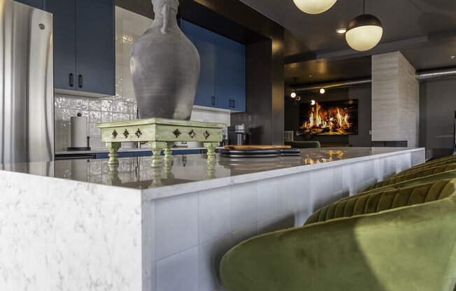a kitchen with a marble counter top and a fireplace