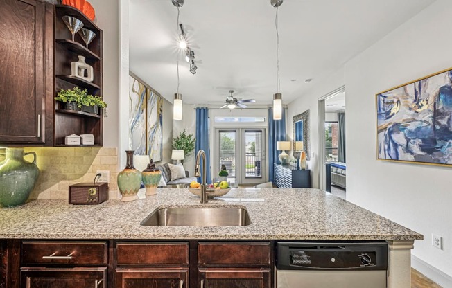 Open-concept kitchen and living area with a breakfast bar and stylish decor at Allusion at West University apartments in Houston, TX