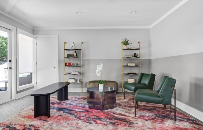 a living room with green chairs and a table