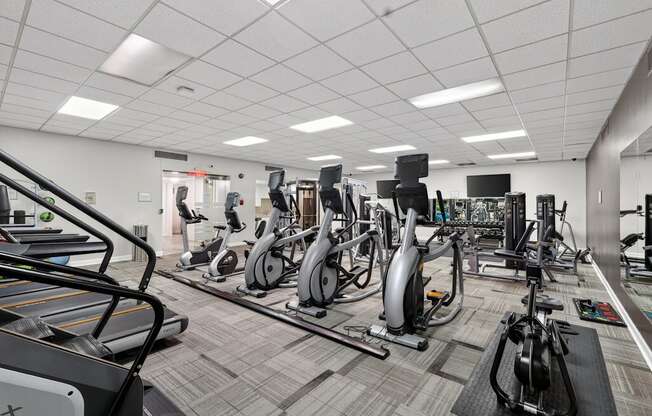 A gym with a variety of exercise equipment.