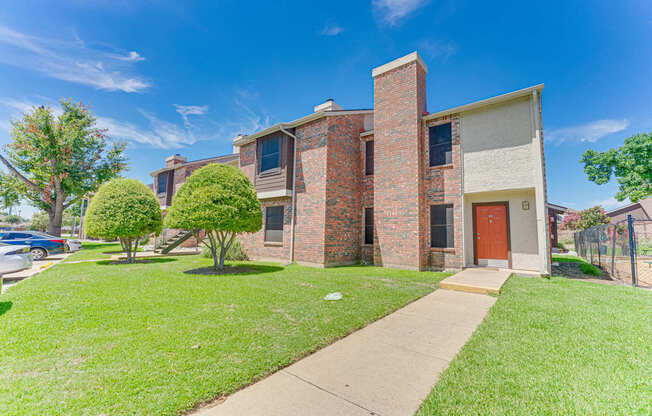 A house with a red door and a brick chimney.