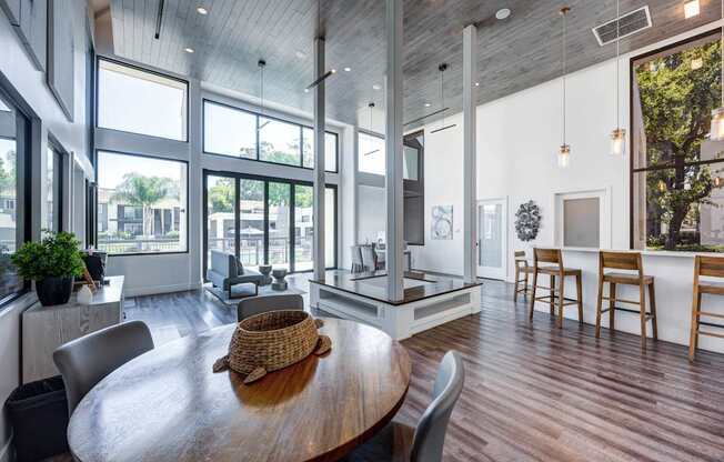 A modern dining room with a wooden table and chairs.