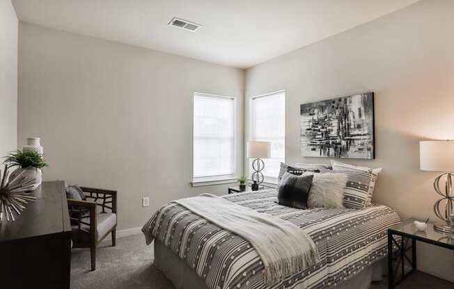 a bedroom with a bed and two windows at Aventura at Aventura at Hawk Ridge, Missouri