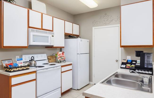 a kitchen with white appliances and wooden cabinets