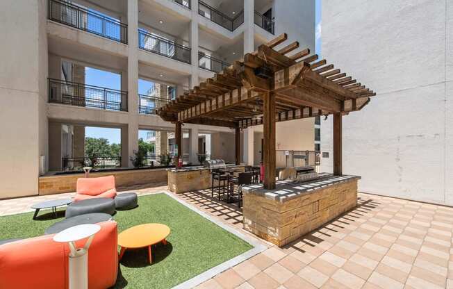 a lounge area with a bar and a pergola