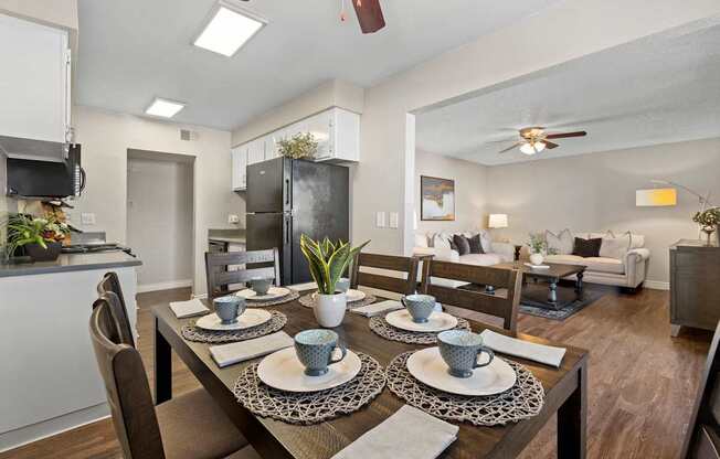 A modern dining room with a table set for two.