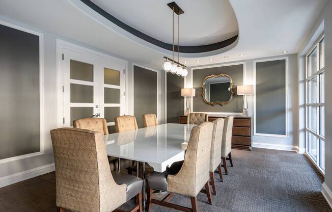 Conference room at our apartments in Alexandria, featuring a long conference table and ornate chairs surrounding it.