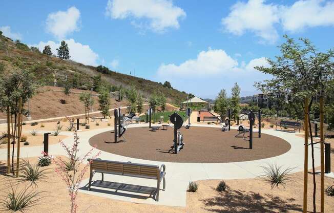 a park with benches and trees and a playground