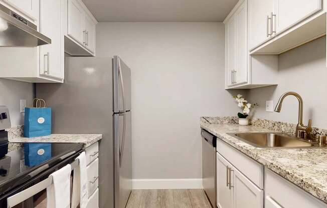 A kitchen with a granite countertop and a sink.