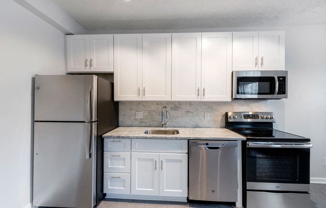 Stainless Steel Kitchen and White Cabinets at Connecticut Plaza Apartments, Washington, District of Columbia.