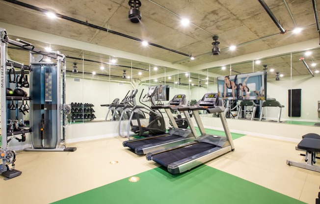 a spacious gym with treadmills and other exercise equipment