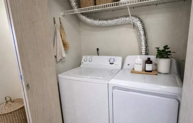 A small laundry room with a washer and dryer.