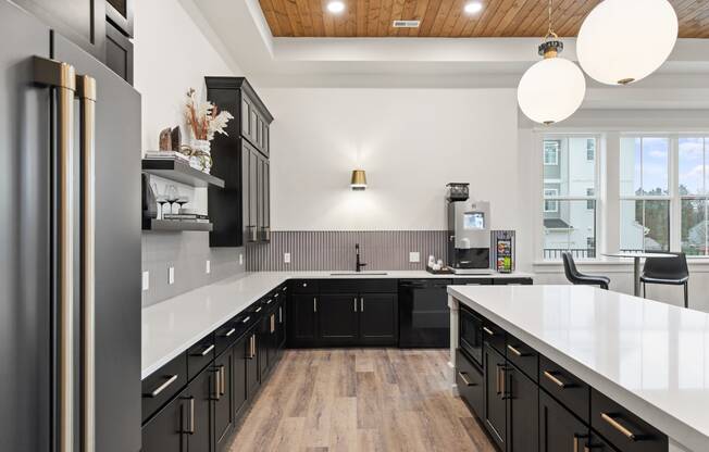 Large kitchen with black cabinets and white counter topsat Hadley Place Apartments, Enola