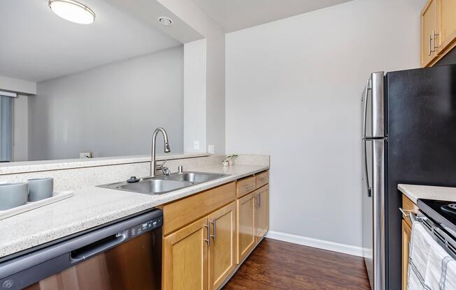 a large kitchen with stainless steel appliances and wooden cabinets