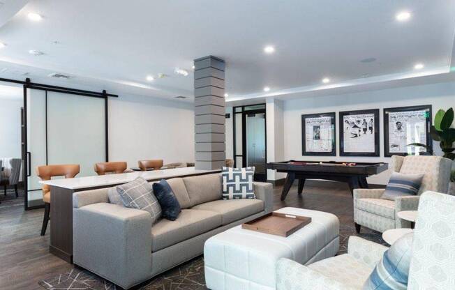 a game room with a pool table and couches