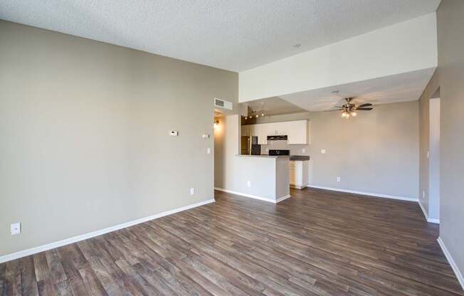 A room with wooden flooring and a ceiling fan.