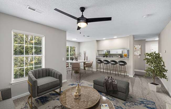 addison point interior staged model an open living room and kitchen with a ceiling fan