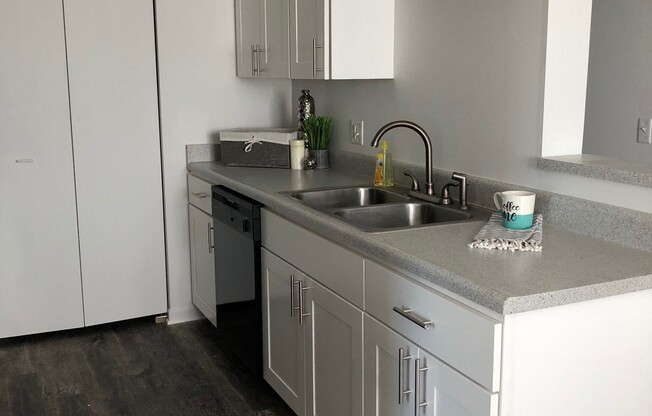 bright white clean cabinets, wood flooring, premium countertops and appliances at regency apartments in Bettendorf Iowa