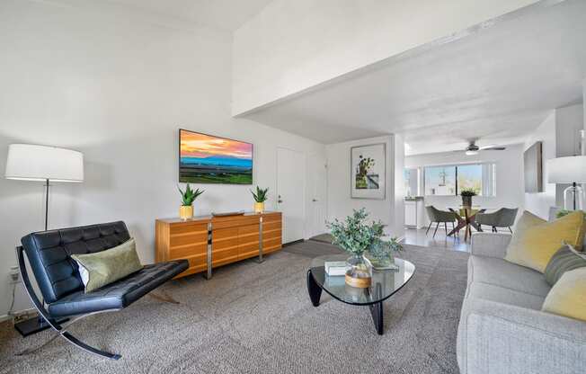 a living room with a couch and a glass coffee table