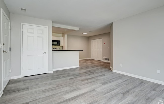 an empty living room and kitchen in a new home