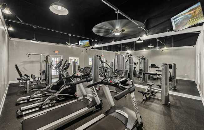 A gym with treadmills and other exercise equipment.