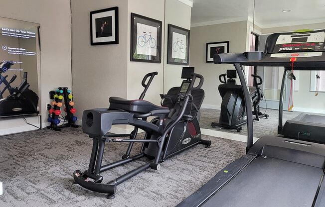 a home gym with exercise equipment and a piano at Ivy Plains at Brooks Apartments, San Antonio , TX