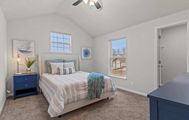 a bedroom with a bed and a ceiling fan